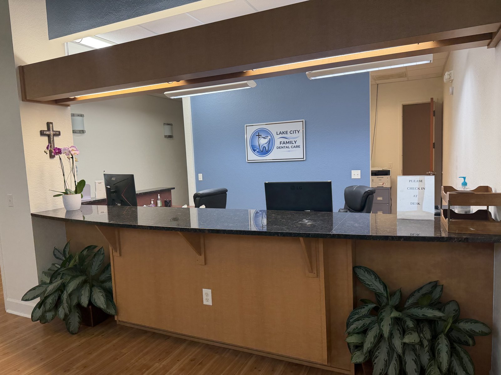 Front desk and reception with logo on blue accent wall